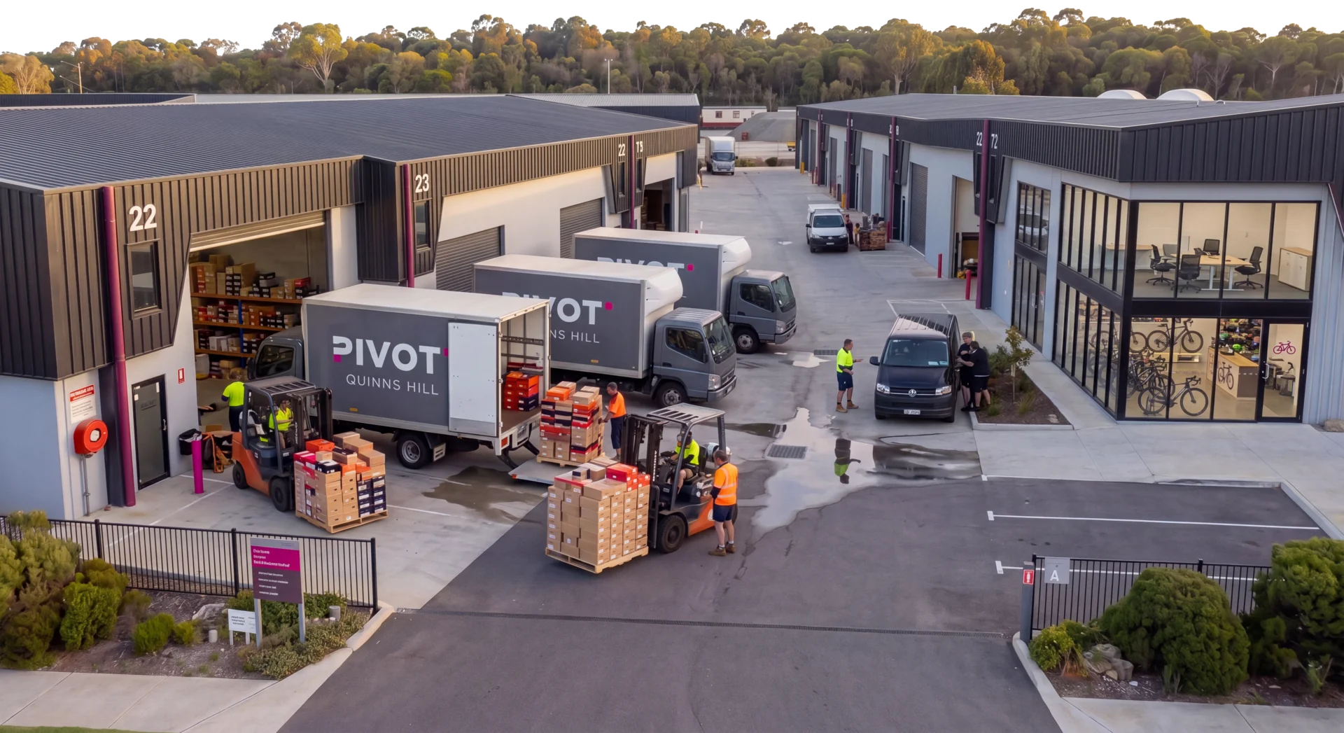 Aerial view of Pivot Quinns Hill at dusk, trucks loading outside the units